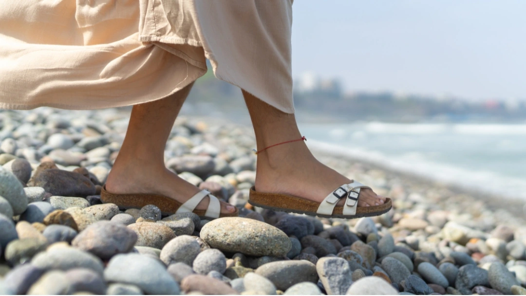 A variety of supportive sandals for hypermobility, displayed in an outdoor setting