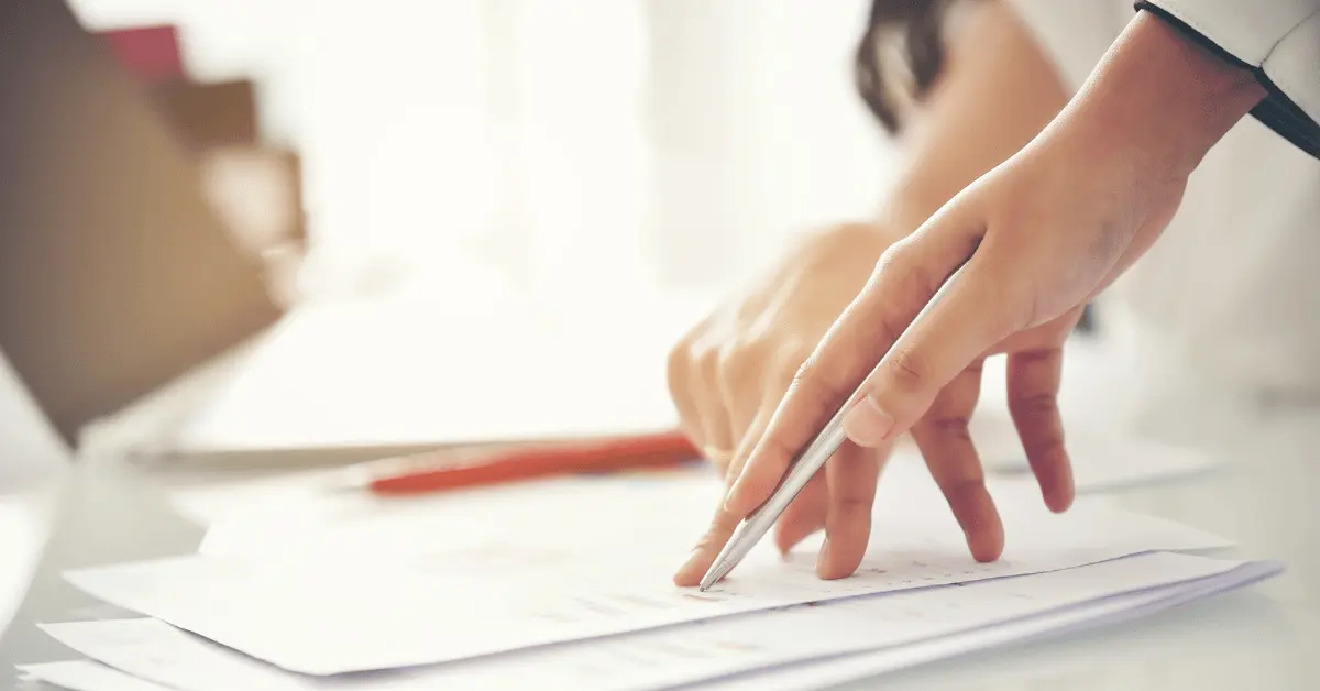 A woman reviewing chronic illness inspired medical POA and other legal documents for her and her family to be prepared for anything.