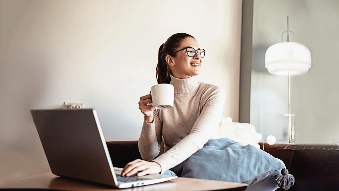 A person with a chronic illness comfortably working from home on a laptop